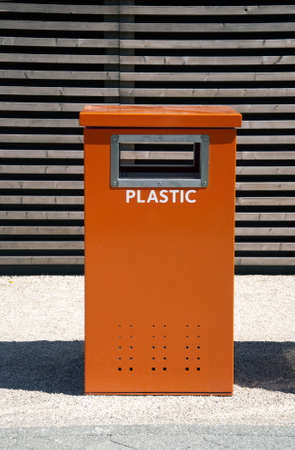 Orange trash can for recycling plasticの写真素材