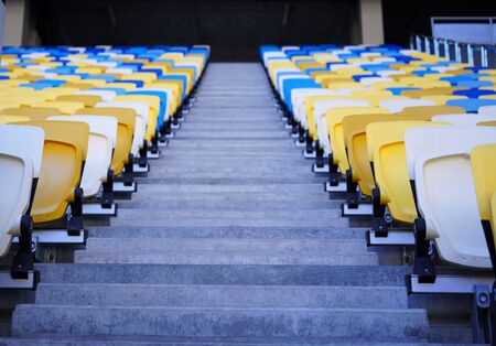 football stadium tribune. Plastic seats of the open stadium, close-up. Rows of seats for spectators of sporting events, going into the distance perspectiveの写真素材