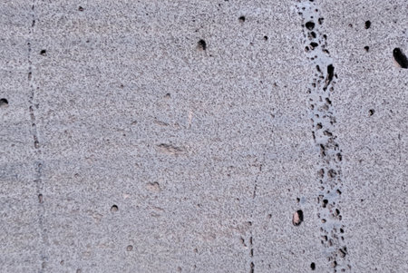 Texture of gray concrete wall with cracks. Abstract background for design.