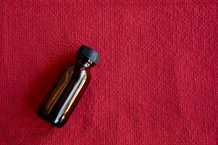 Various sized of amber glass bottle on red backgroundの写真素材