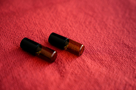 Various sized of amber glass bottle on red backgroundの写真素材