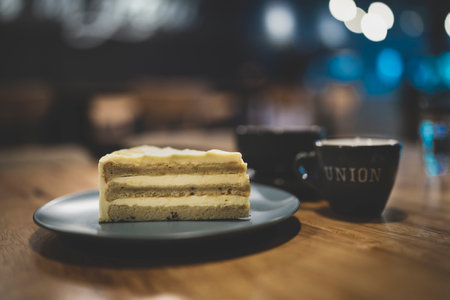 Coffee cup and cake on wooden table in the cafe.の写真素材
