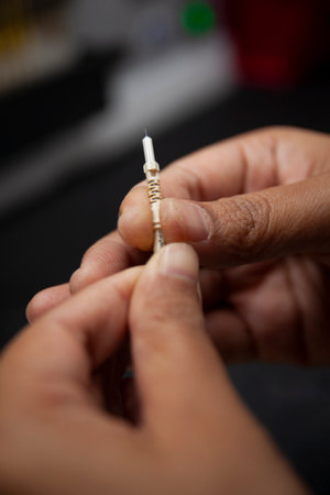 Close-up of a man's hand using a nail file to cut nails