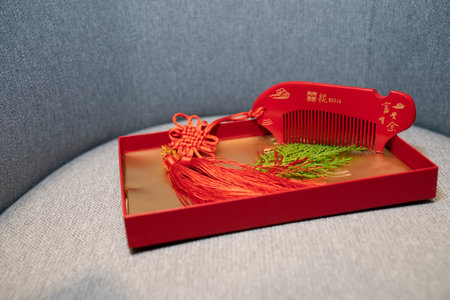 Chinese New Year decoration with red gift box on gray sofa background.の写真素材