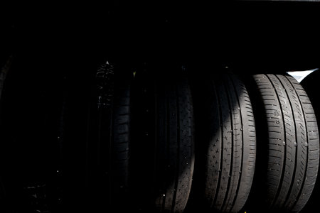 Car tires on a black background, close-up of photo.の写真素材