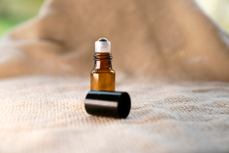 Aromatherapy essential oil in a small bottle on a towelの写真素材