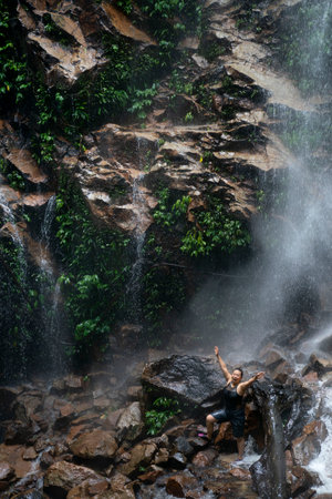 Long Exposure photograph of water flowing down a creek with a misty forest in the background.