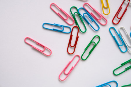 Coloured paper clips close-up on a white backgroundの写真素材