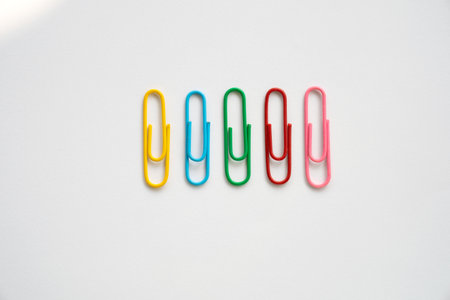 Coloured paper clips close-up on a white background