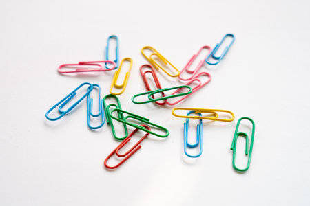 Coloured paper clips close-up on a white background