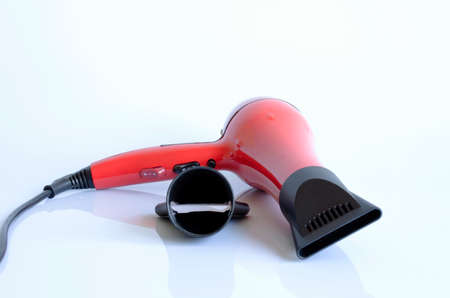 Single red hairdryer isolated on white backgroundsの写真素材