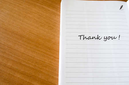 White blank notepad on office wooden table and words 
