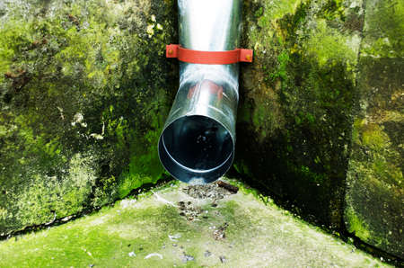 Aluminum rain gutter with green leaves backgroundの写真素材