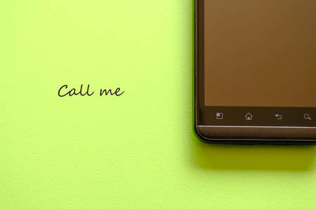 Smart phone on green background and message placeの写真素材