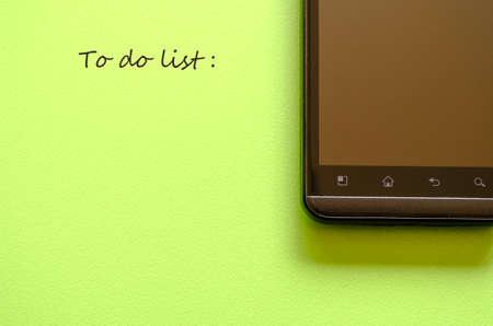 Smart phone on green background and message placeの写真素材