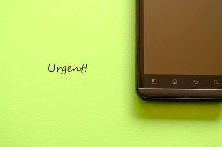 Smart phone on green background and message placeの写真素材