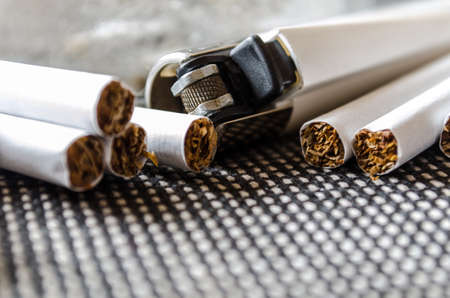 Ashtray and lighter on a dark background closeupの写真素材