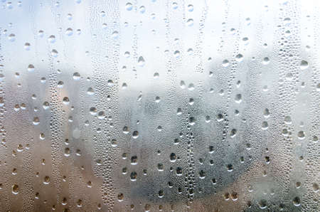 Closeup of natural water drop on glass background