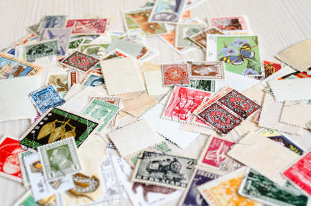 Backdrop of old worldwide postage stamps .のeditorial素材