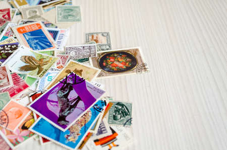Backdrop of old worldwide postage stamps .のeditorial素材