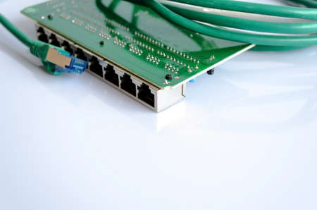 Green network cable and switch on white
