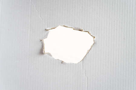 A hole in the paper and place for conceptual textの写真素材