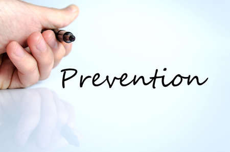 Human hand writing Prevention isolated over white background - business conceptの写真素材