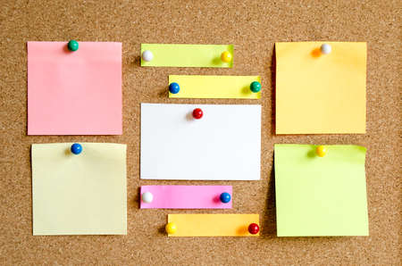 Colorful sticky notes on cork board background