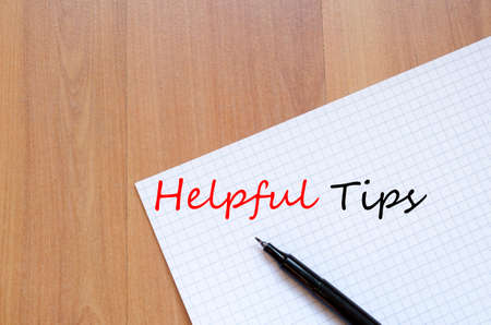 White blank notepad on office wooden table Helpful Tips conceptの写真素材