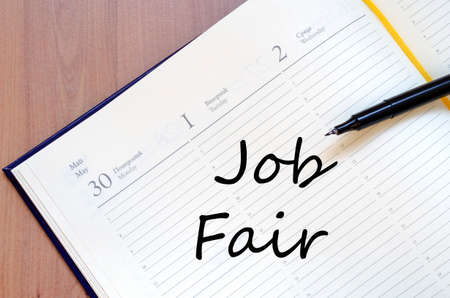 Yellow blank notepad on office wooden table Job Fair conceptの写真素材