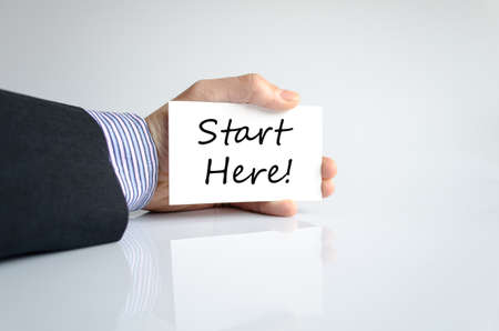 Start here hand concept isolated over white backgroundの写真素材