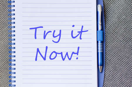 Blue notepad and Try it now text conceptの写真素材