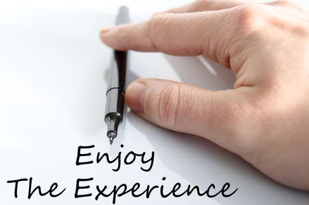 Enjoy the experience text concept isolated over white backgroundの写真素材