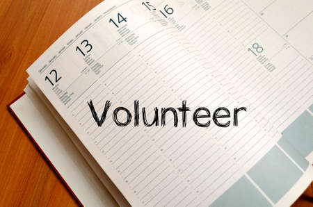 Volunteer text concept write on notebookの写真素材