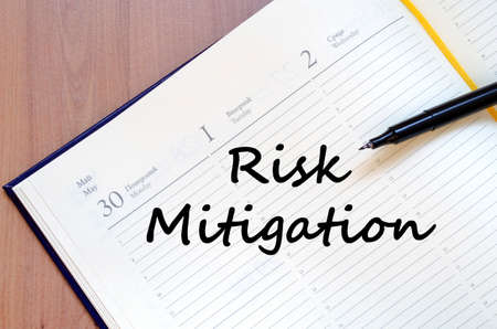Risk mitigation text concept write on notebook with penの写真素材