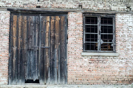 Old wooden door at brick buildingの写真素材