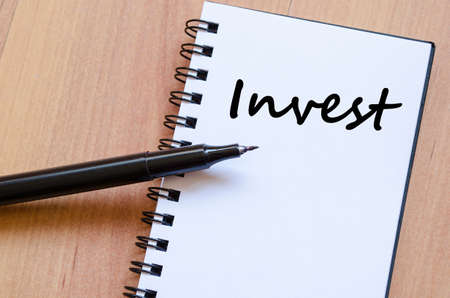 Invest text concept write on notebook with penの写真素材