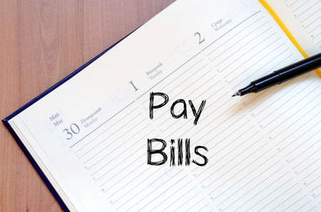 Pay bills text concept write on notebook with penの写真素材
