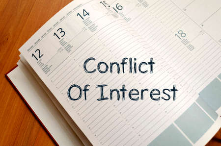 Conflict of interest text concept write on notebook with penの写真素材
