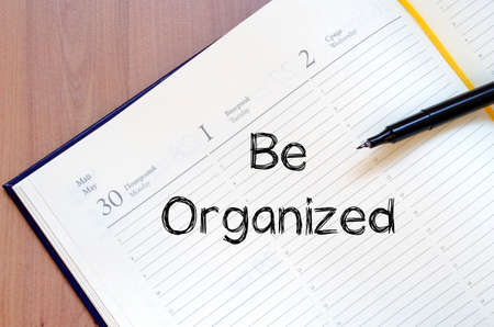 Be organized text concept write on notebook with penの写真素材