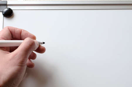 Human hand and whiteboard with place for textの写真素材