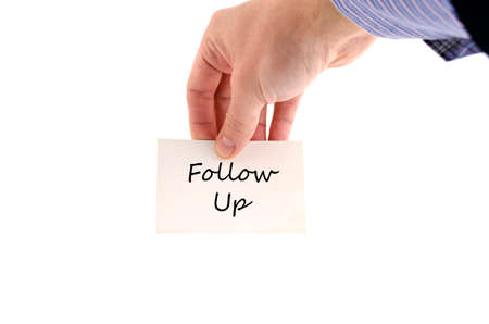 Follow up text note in business man handの写真素材