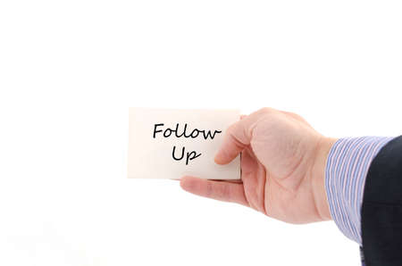 Follow up text note in business man handの写真素材