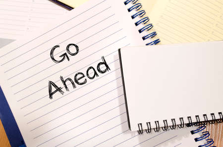 Go ahead text concept write on notebookの写真素材