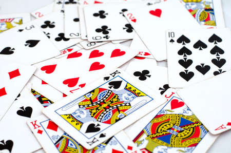 Lot of dusty old playing cards isolated over white backgroundの写真素材