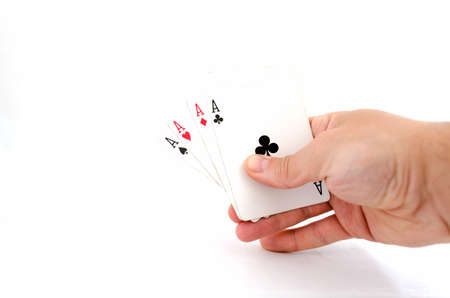 Playing cards in hand isolated on white backgroundの写真素材