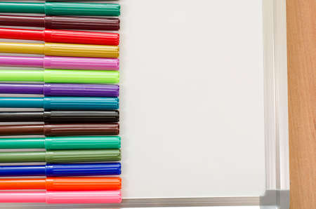 Felt-tip pen and whiteboard on a wooden backgroundの写真素材