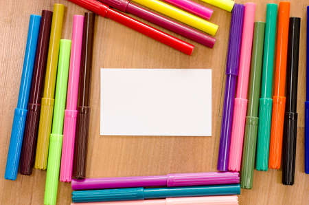 Felt-tip pen and note on a wooden backgroundの写真素材