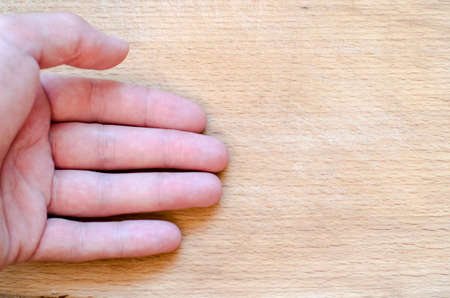 Human hand over wooden background and place for textの写真素材