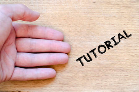 Human hand over wooden background and tutorial text concept